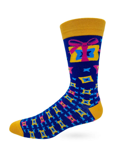 Men's novelty crew sock in blue with yellow accents featuring a colorful gift box pattern, part of the God's Gift To Women collection.