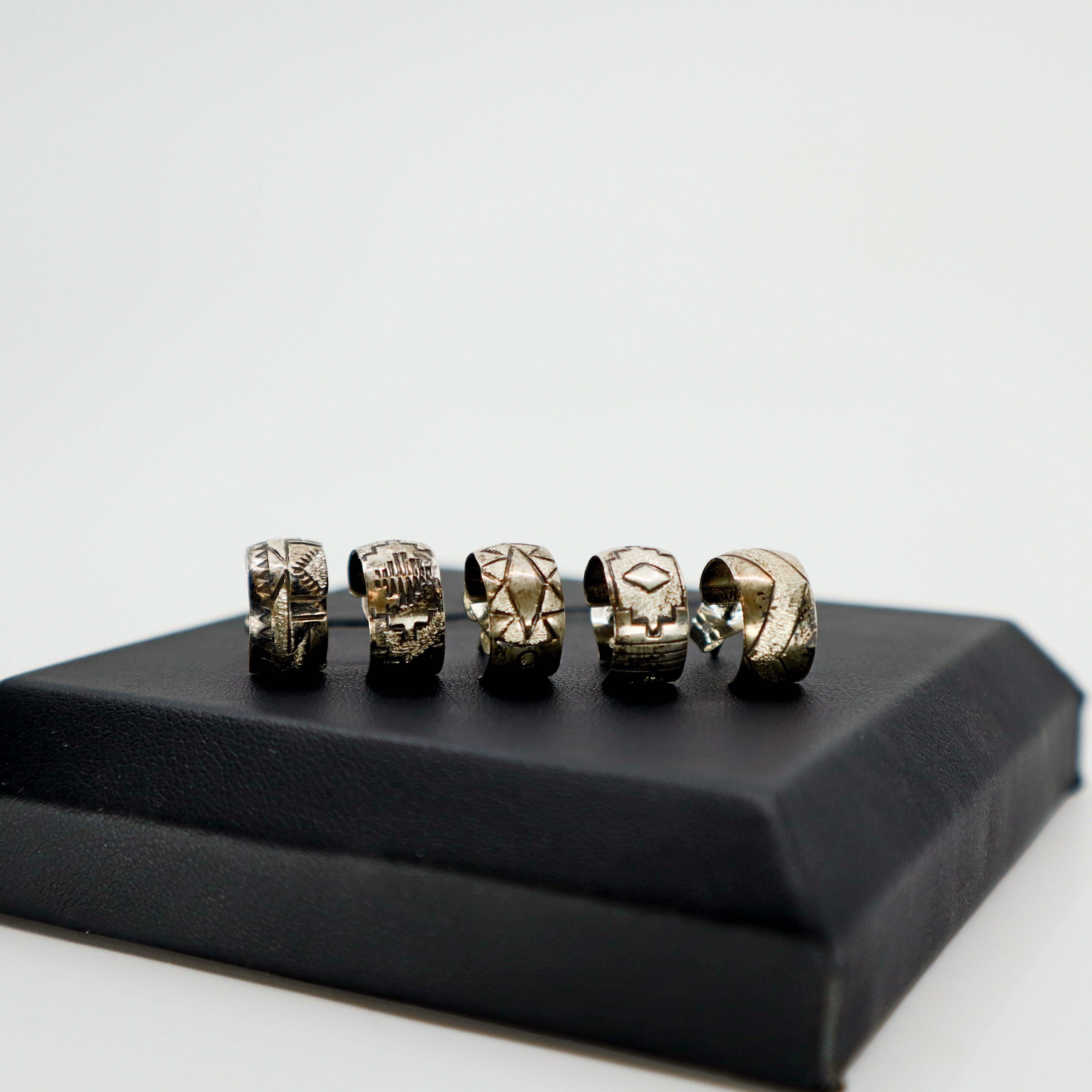 Handmade sterling silver stamped mini hoop earring with textured design