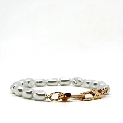 Close-up of glitter pearl phone lanyard with gold clasp and keychain attachment on white background