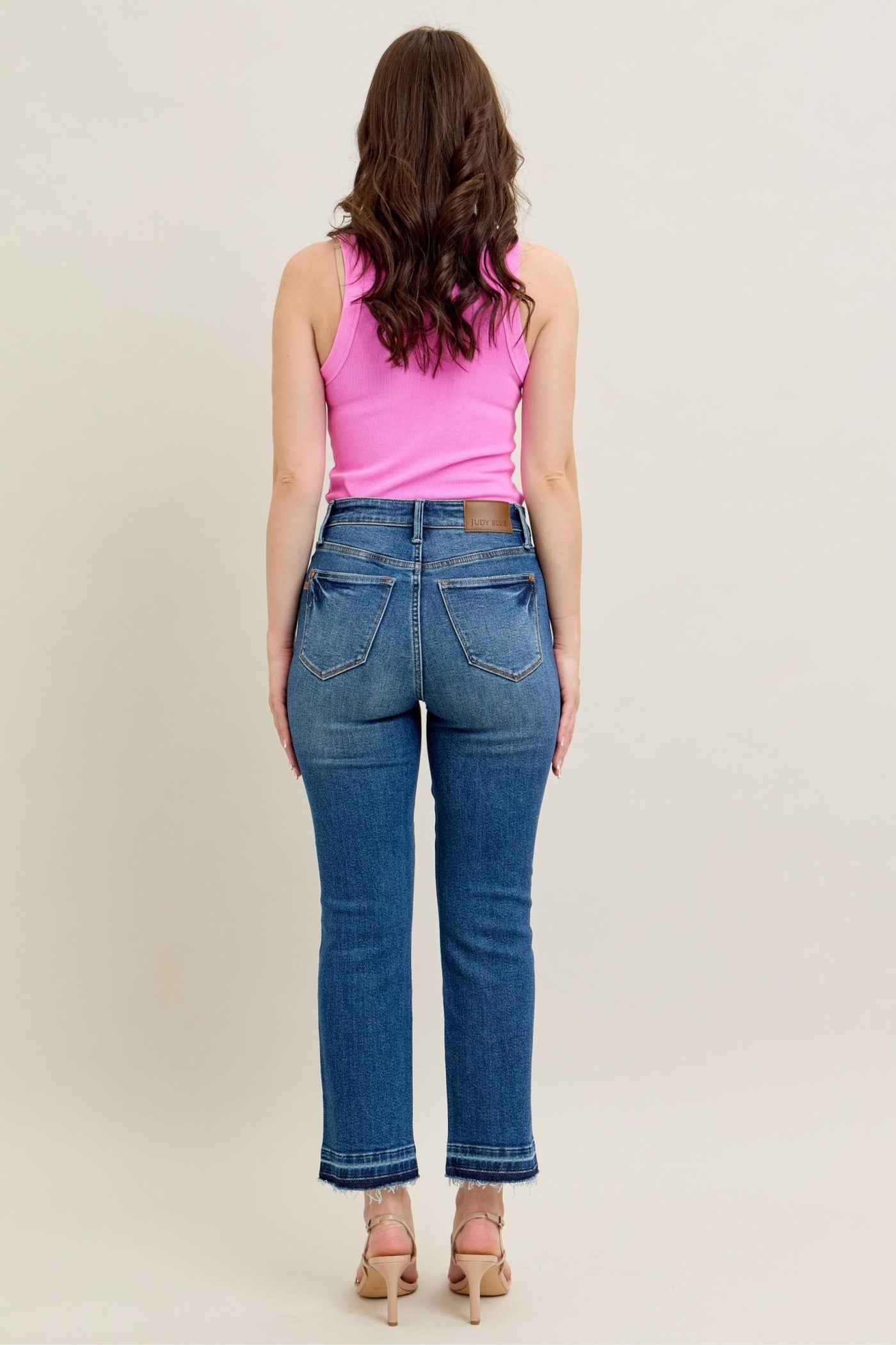 Judy Blue Jeans with high-rise fit and kick flare silhouette, showcasing vintage wash and raw hem.