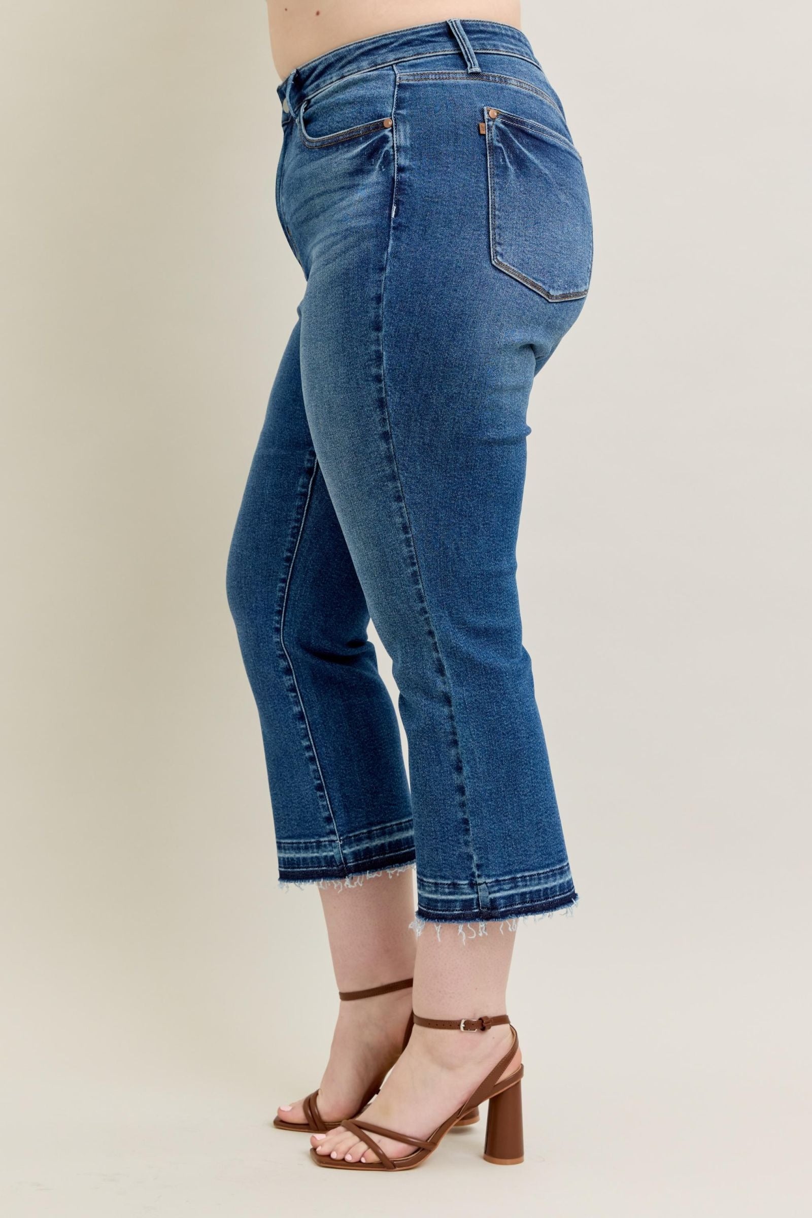 High-rise Judy Blue Jeans 88981 with vintage wash, kick flare, and raw hem.
