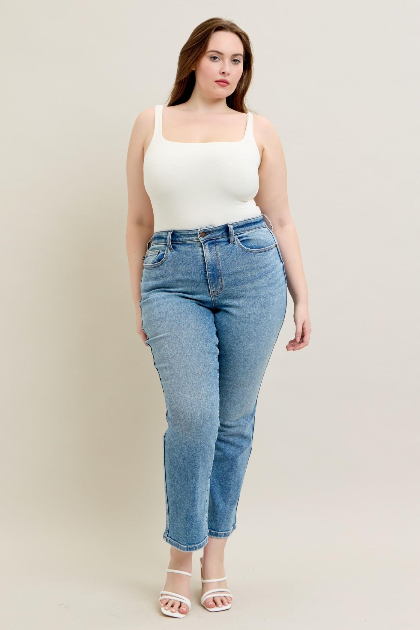 High Waist Vintage Straight Jeans in light blue denim, modeled by a plus-size person wearing a white top.