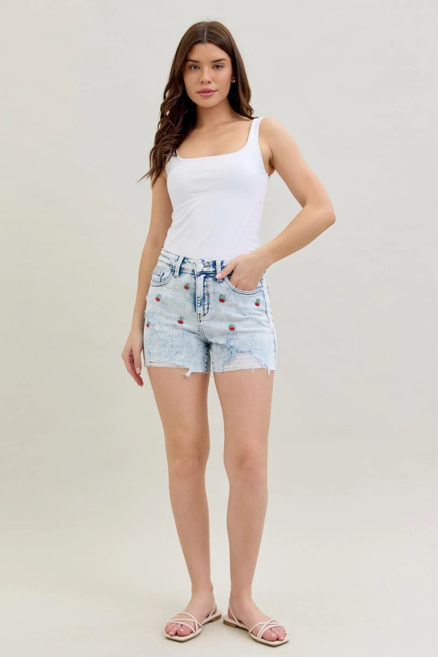 Judy Blue Shorts with high-rise waist, acid wash finish, cherry embroidery, and 4-inch inseam.
