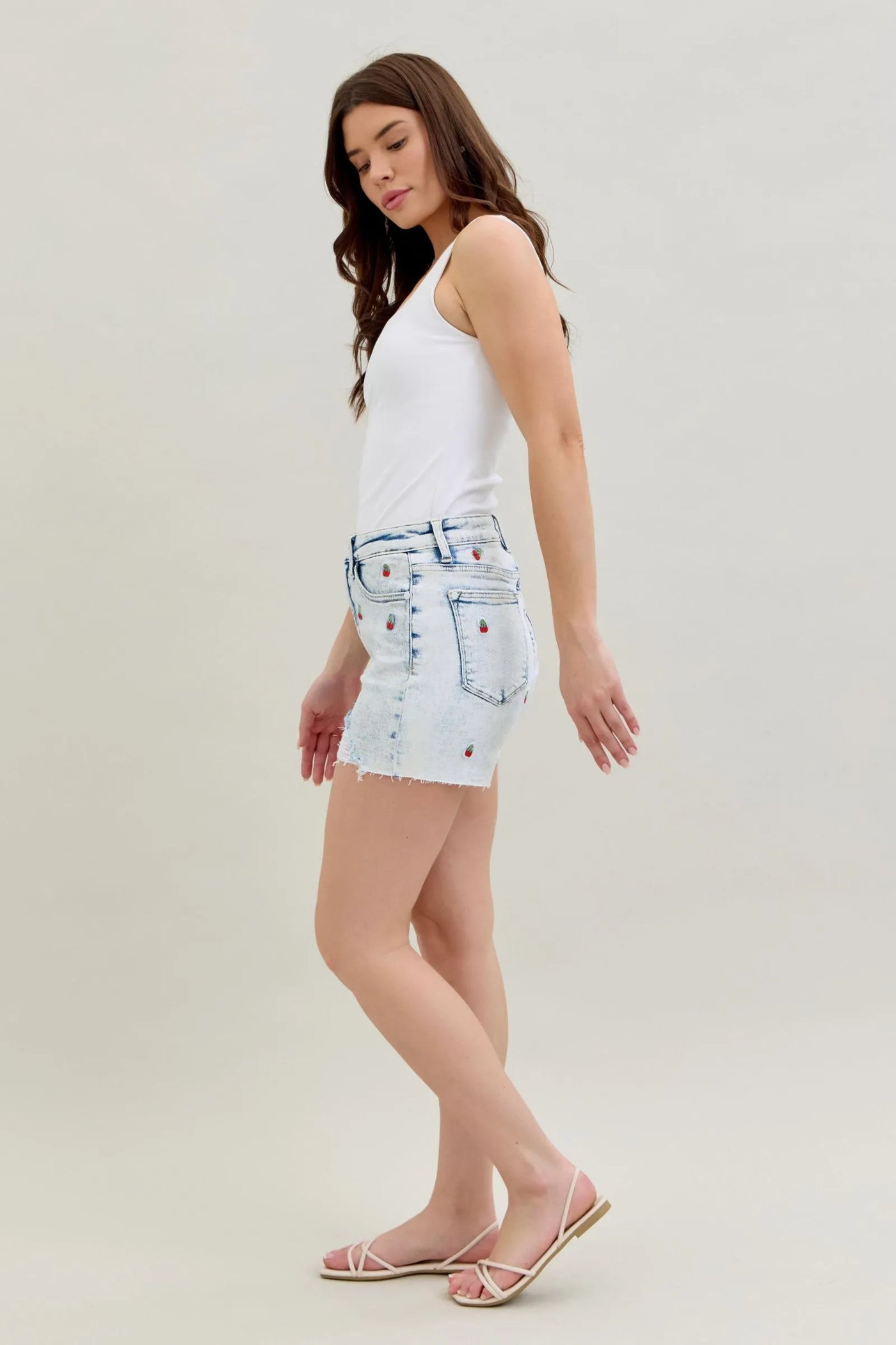 High-rise Judy Blue Shorts with acid wash and cherry embroidery, 4-inch inseam.