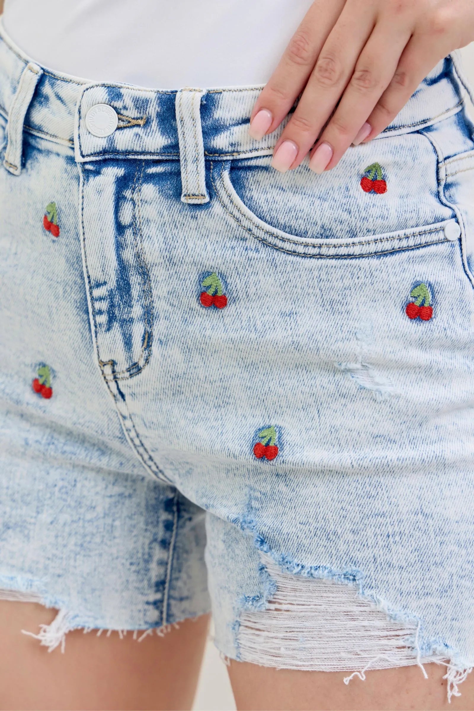 Judy Blue Shorts with high-rise waist, acid wash finish, cherry embroidery, and 4-inch inseam.