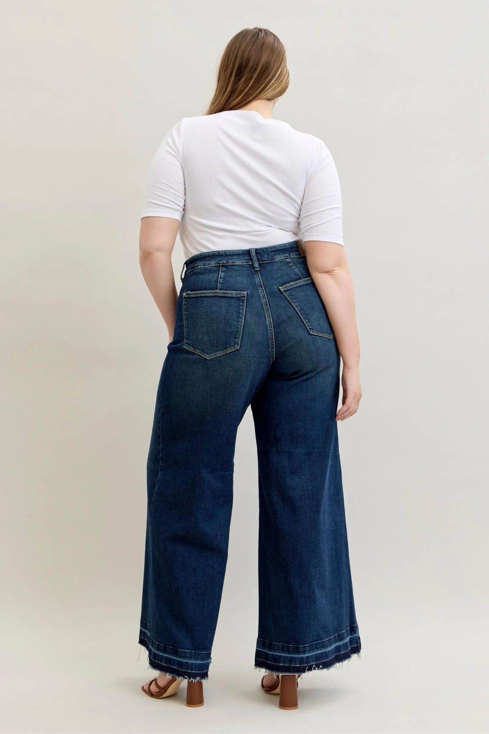 Plus size model wearing Judy Blue Jeans 881046 high waist palazzo wide-leg dark blue denim with back patch pockets