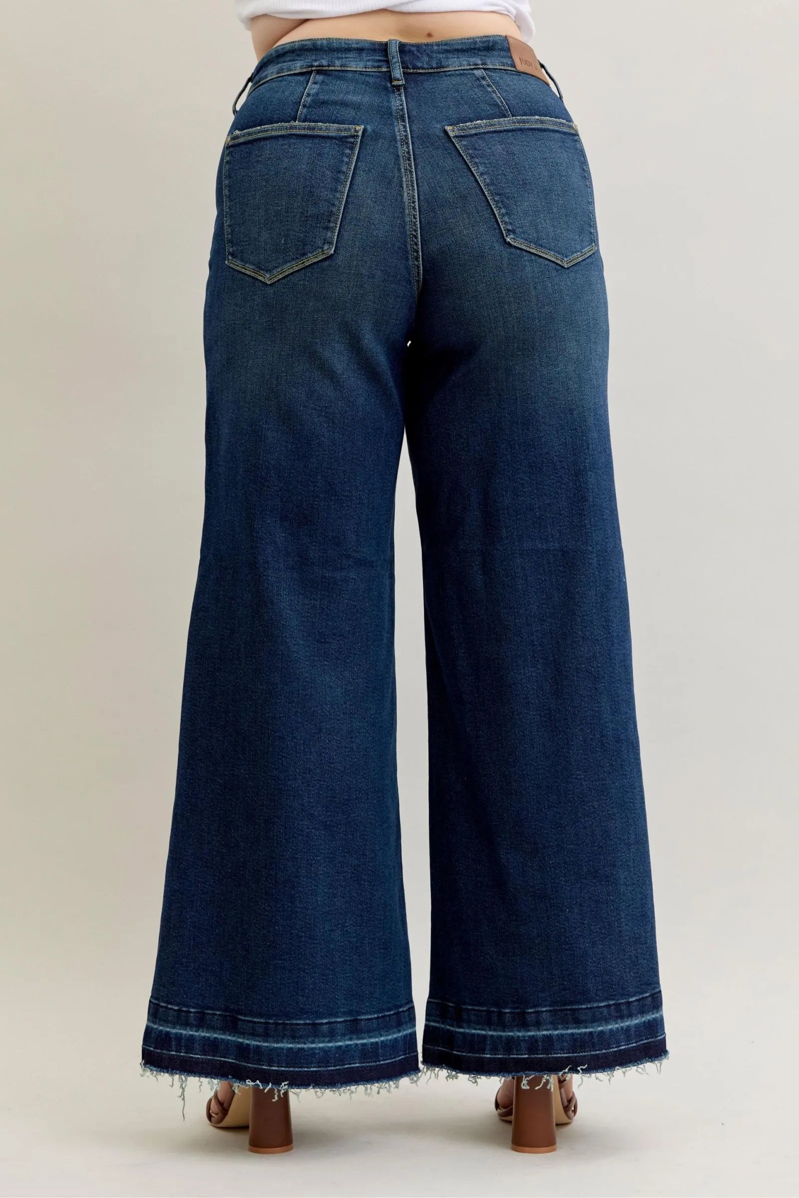 Back view of Judy Blue Jeans 881046 high waist wide-leg palazzo jeans in dark blue denim with frayed hem and patch pockets