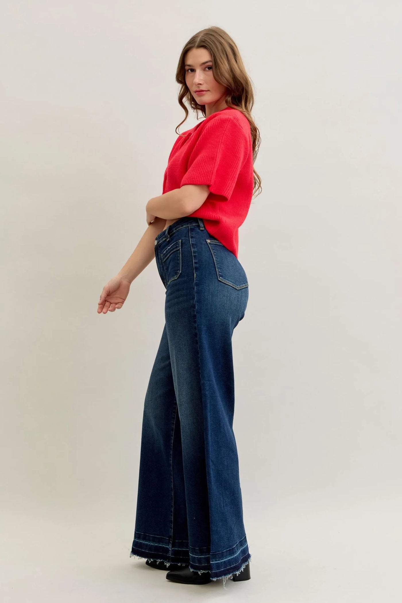 Woman wearing Judy Blue Jeans high waist palazzo wide-leg denim with front patch pockets and red top