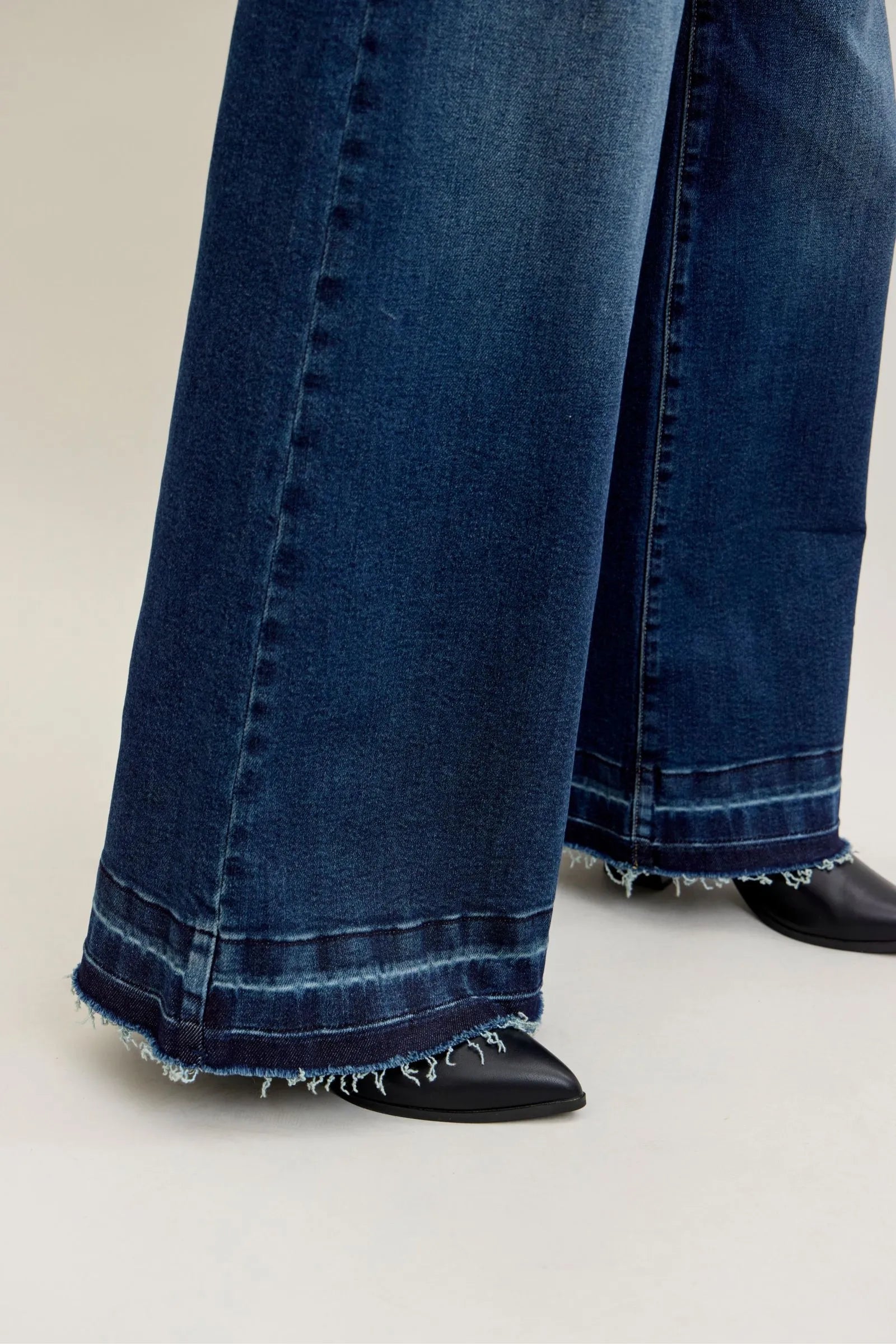 Close-up of Judy Blue Jeans high waist palazzo wide-leg dark denim with raw hem and front patch pocket details