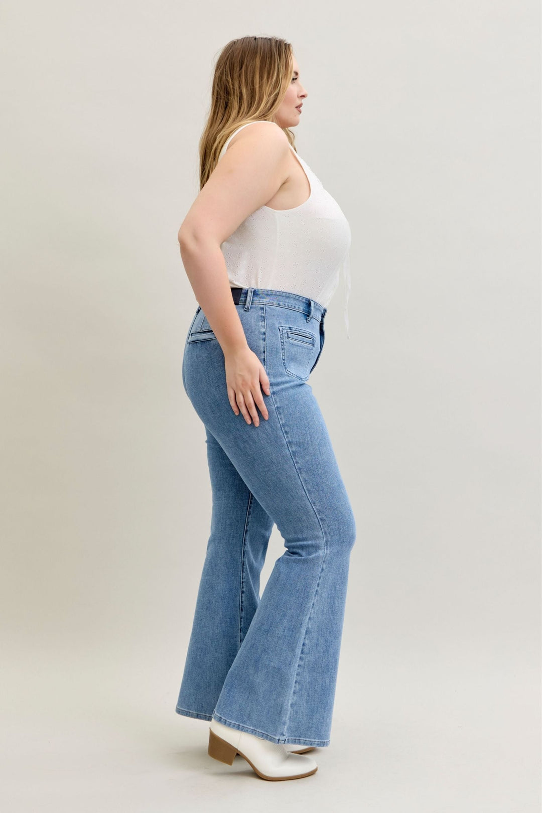 Plus size model wearing Judy Blue Jeans high-rise flare fit with front patch and welt pockets in soft stretch denim