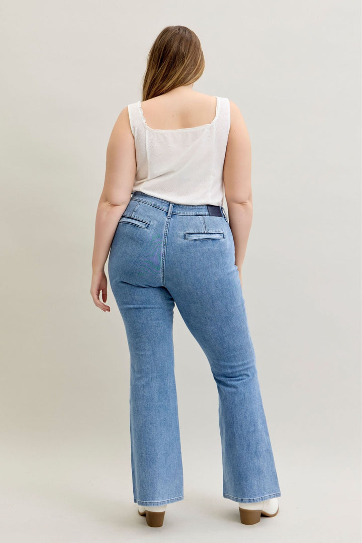 Plus size model wearing Judy Blue Jeans high-rise flare fit in soft stretch denim with patch and welt back pockets