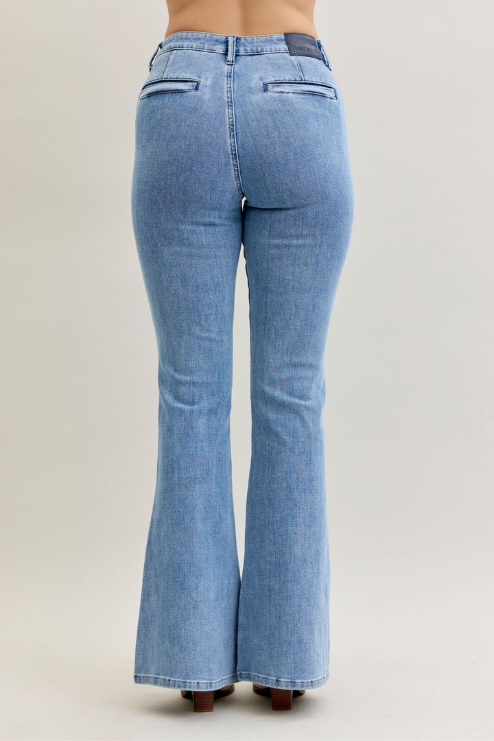 Back view of high-rise flare Judy Blue Jeans in soft stretch light blue denim with front patch and welt pockets and clean finish flare leg