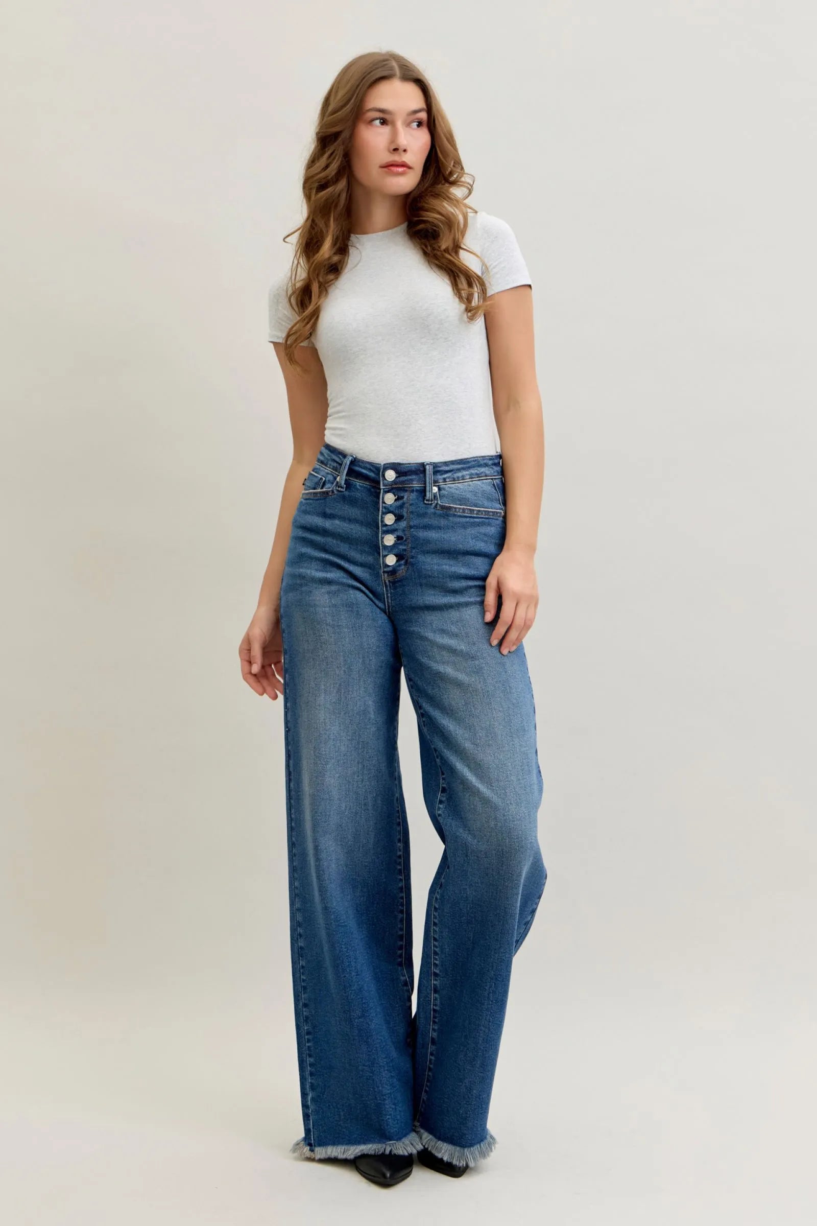 Woman wearing high waist Judy Blue Jeans 881001 with straight-leg fit and button-fly closure
