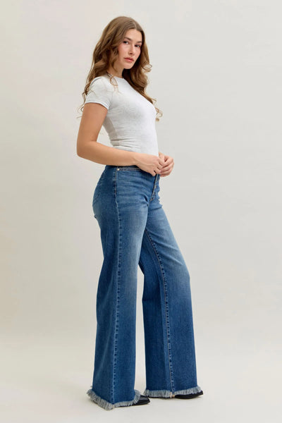 Woman wearing high waist Judy Blue Jeans 881001 with straight-leg fit and button-fly closure
