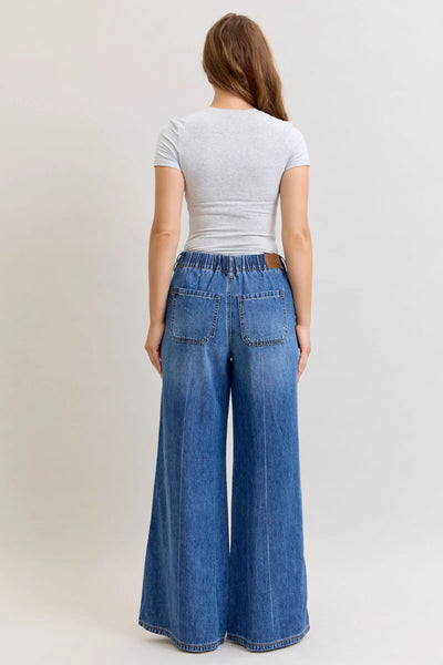 Back view of woman wearing Judy Blue Jeans high waist featherweight palazzo jeans with elastic waistband and wide-leg cut