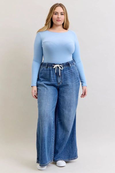 Plus size model wearing Judy Blue Jeans high waist featherweight palazzo jeans with elastic waistband and wide leg cut