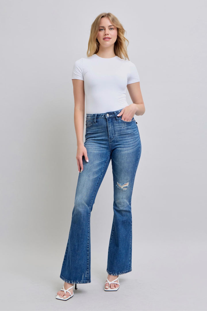 Woman wearing high waist contrast wash destroyed flare Judy Blue Jeans 88383 with white top and sandals