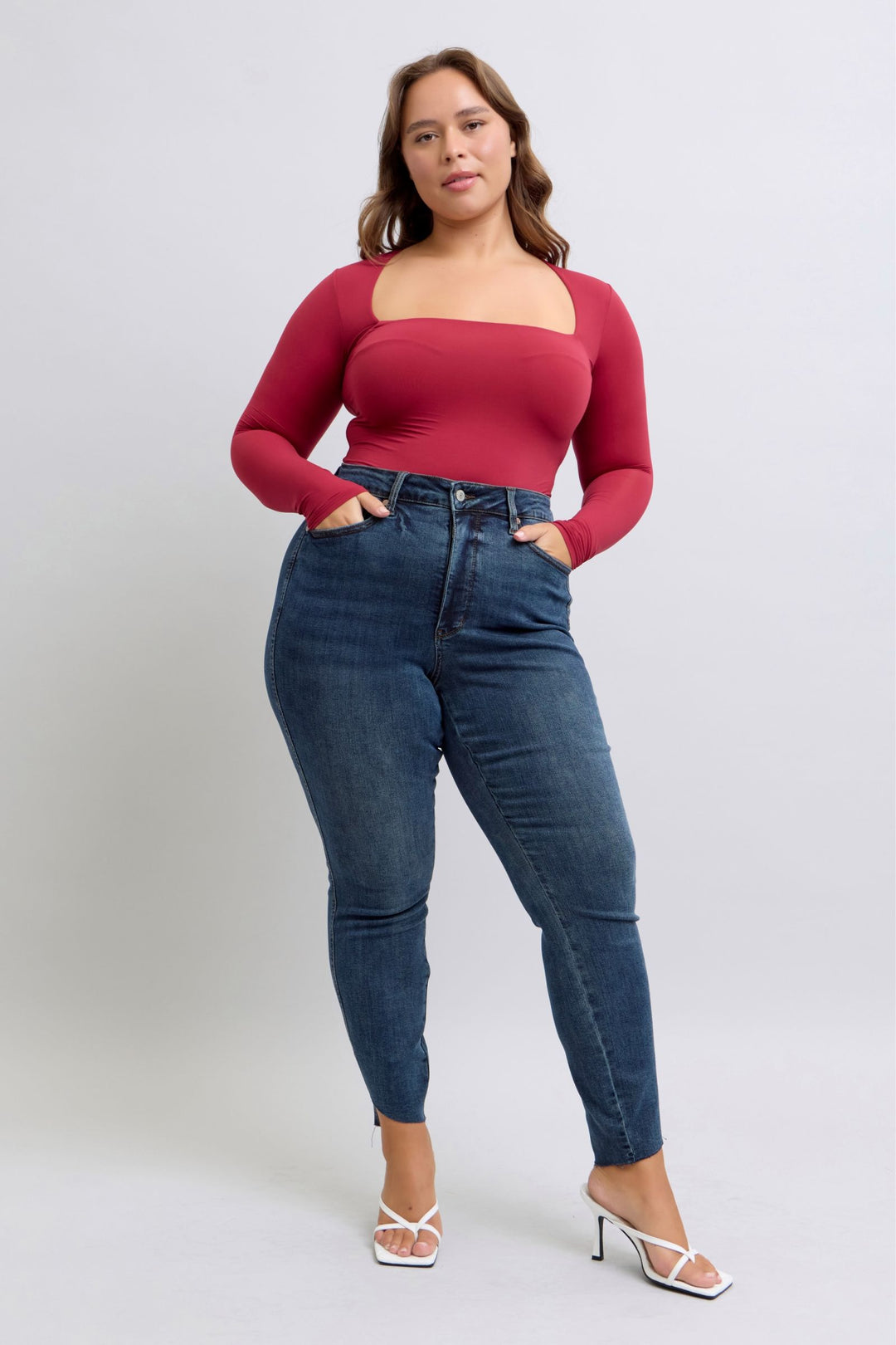 curvy woman wearing high waist tummy control step hem skinny Judy Blue Jeans in dark wash