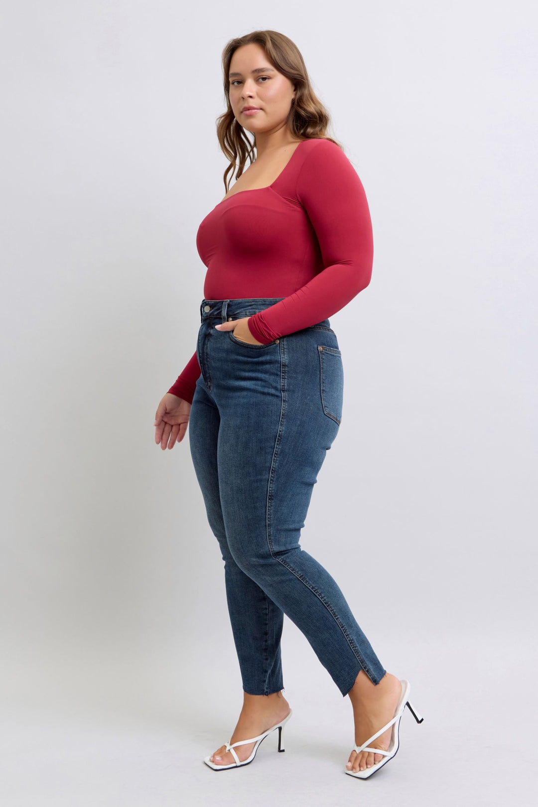 Plus size model wearing Judy Blue Jeans high waist tummy control skinny jeans with step hem