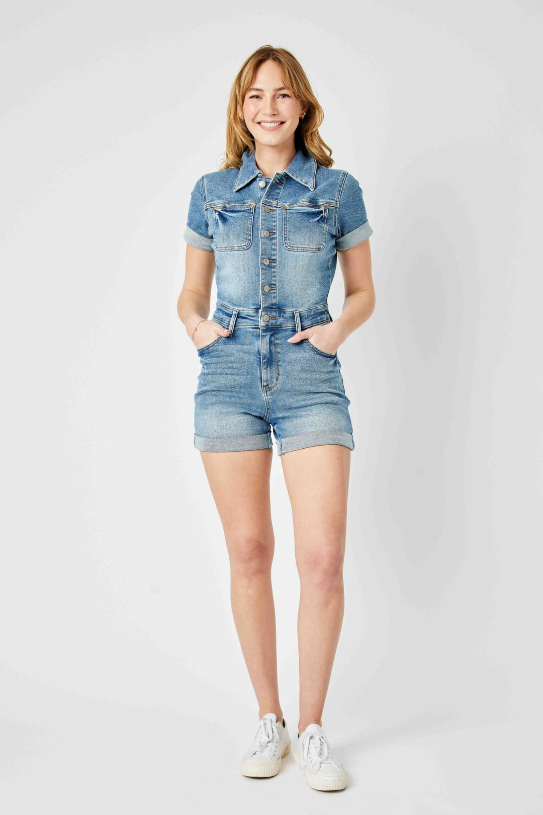 Woman wearing high waisted short sleeve denim romper Judy Blue Overalls with 12.5" rise and 4.25" inseam