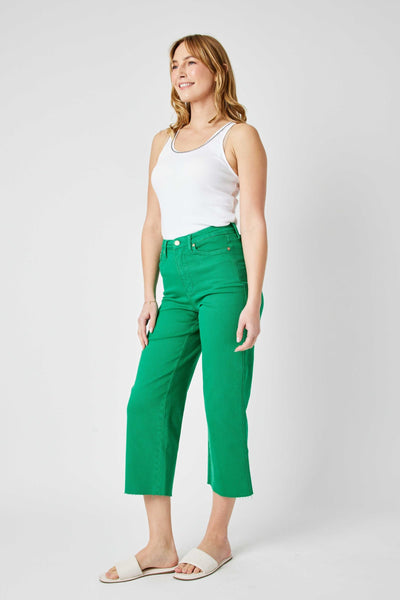 Woman wearing high waist Kelly green wide leg crop Judy Blue Jeans with tummy control and white tank top