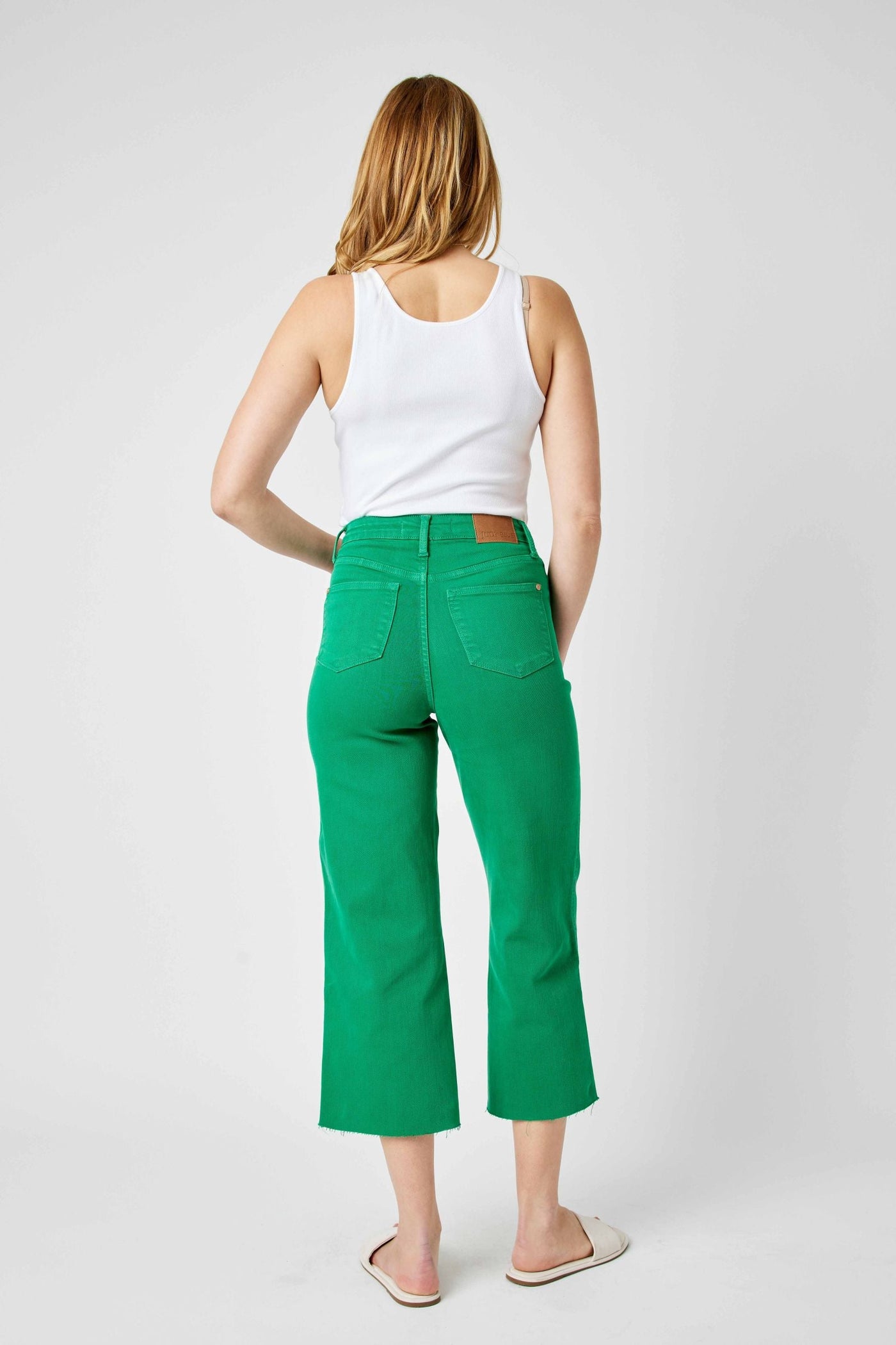 Woman wearing Judy Blue Jeans high waist tummy control Kelly green wide leg crop jeans back view