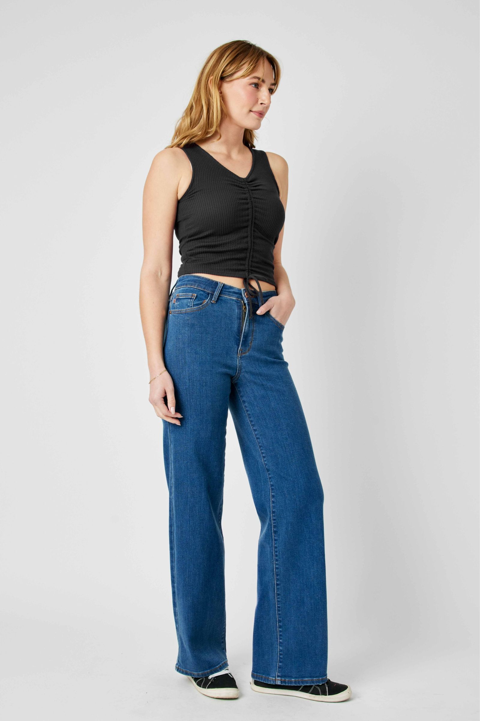 Woman wearing high waisted vintage wide leg Judy Blue Jeans in blue denim