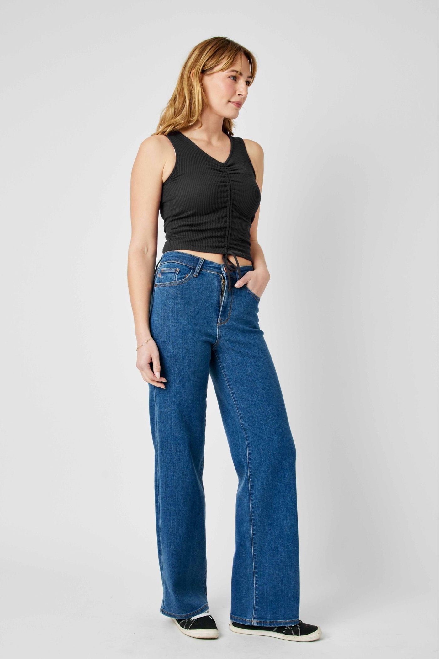 Woman wearing high waisted vintage wide leg Judy Blue Jeans in blue denim