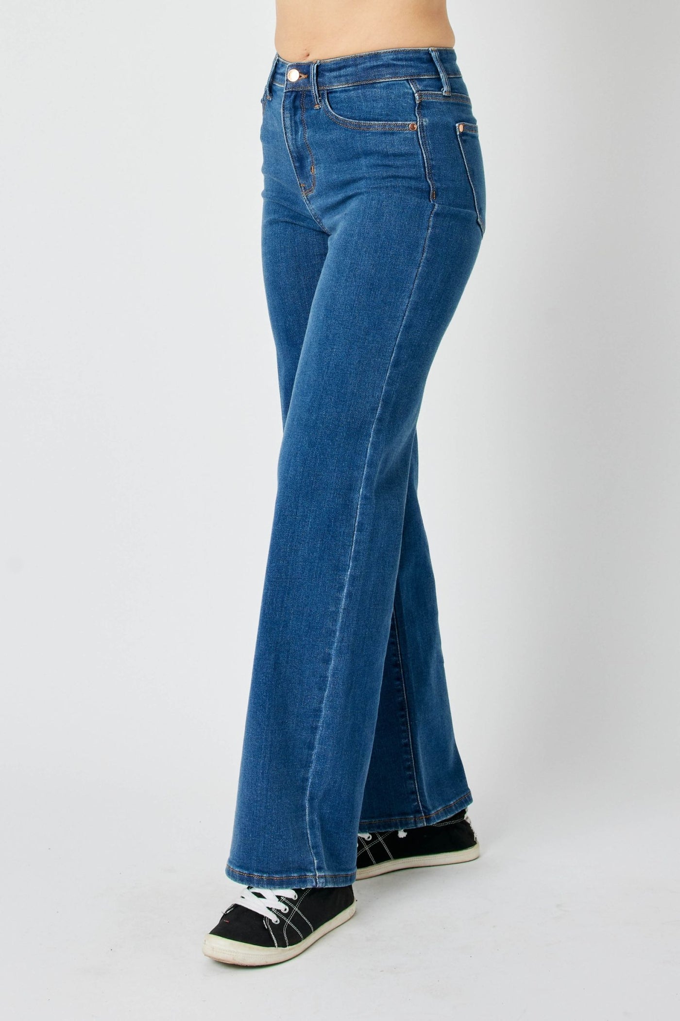 Judy Blue Jeans high-waisted vintage wide leg blue denim pants modeled with black sneakers