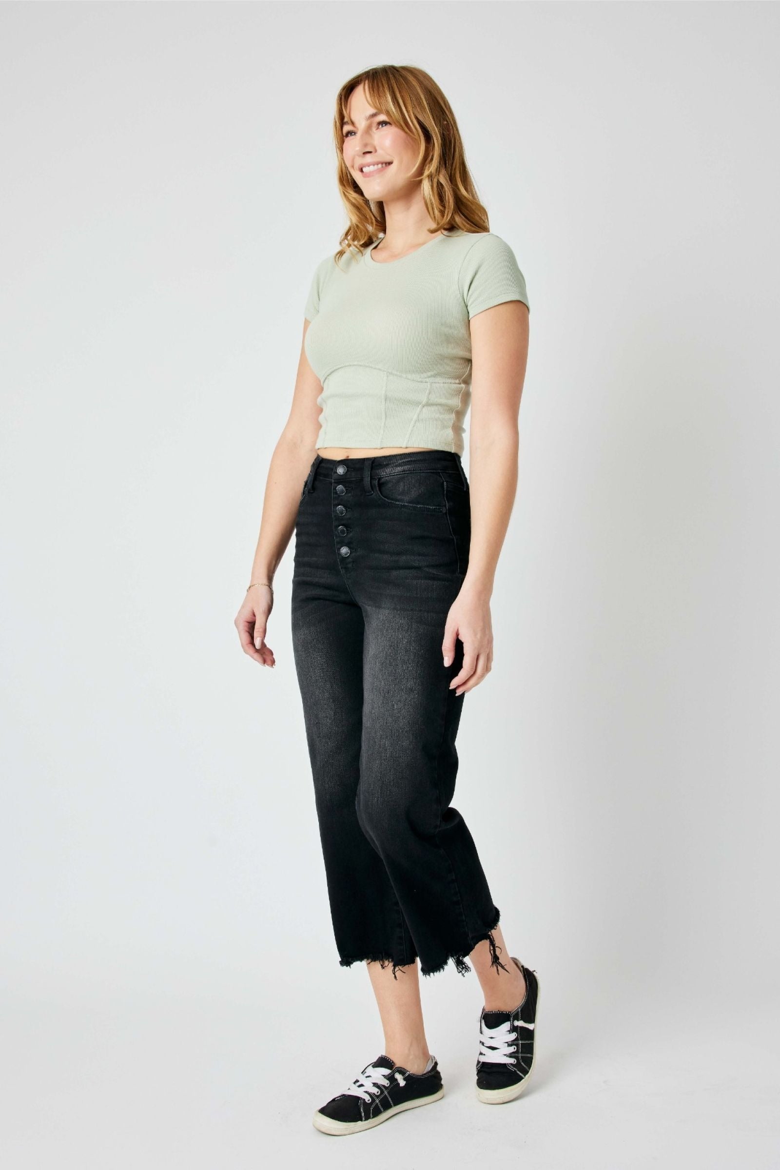 High-rise fit cropped wide leg jeans with distressed design and raw hem detailing.