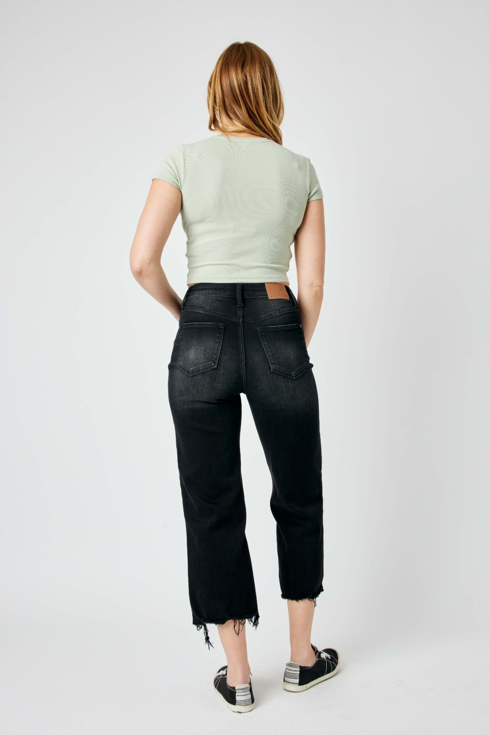 High-rise fit Judy Blue Jeans with distressed design and cropped wide leg in black.