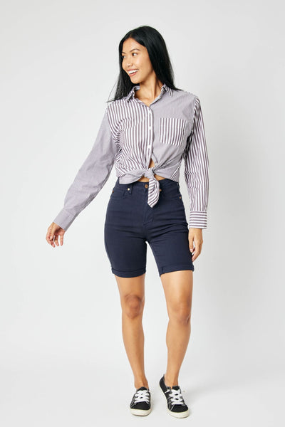High-rise navy Judy Blue Bermuda shorts with tummy control, shown cuffed, perfect for everyday wear.