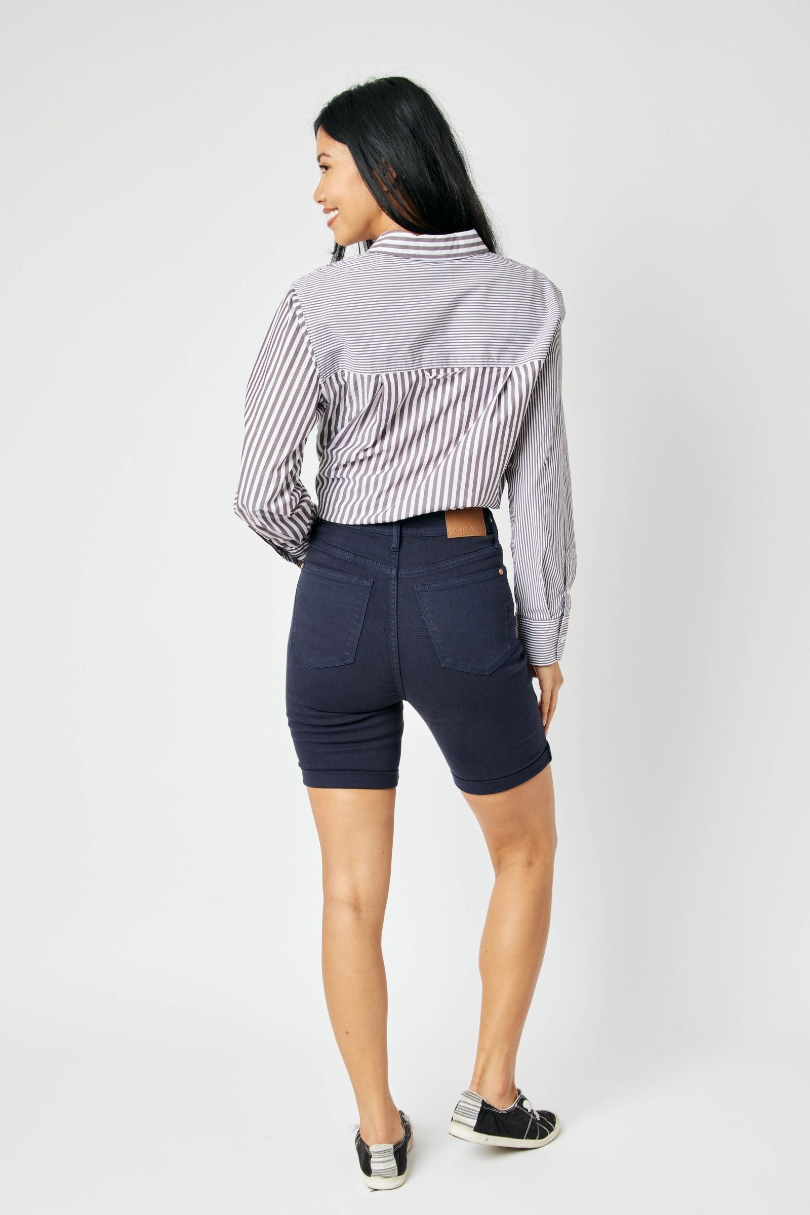 High-rise navy Bermuda shorts with tummy control and flexible fit.