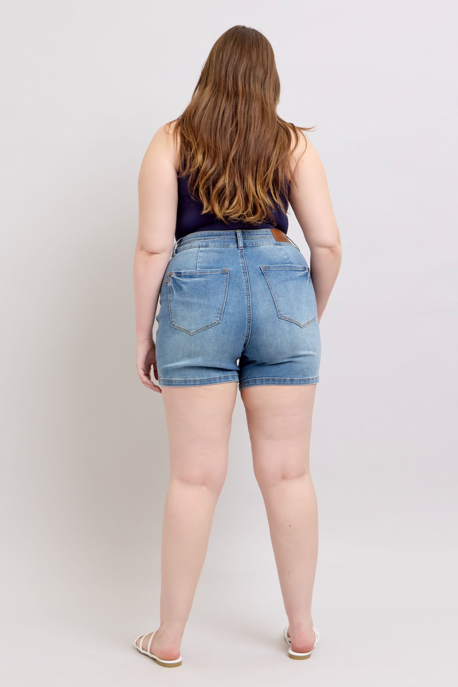 Highwaist tummy control double waistband denim shorts back view.