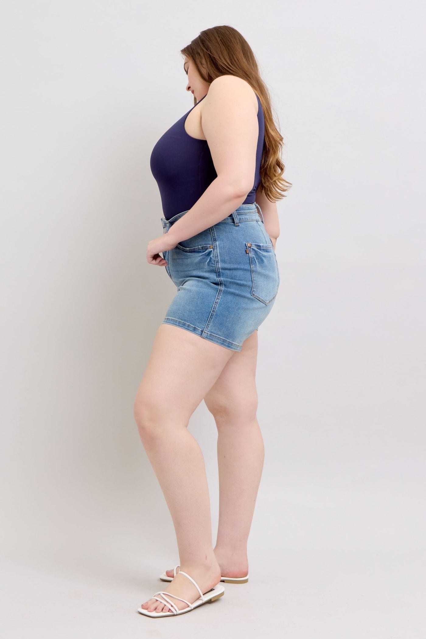 Highwaist tummy control denim shorts with double waistband, side view.