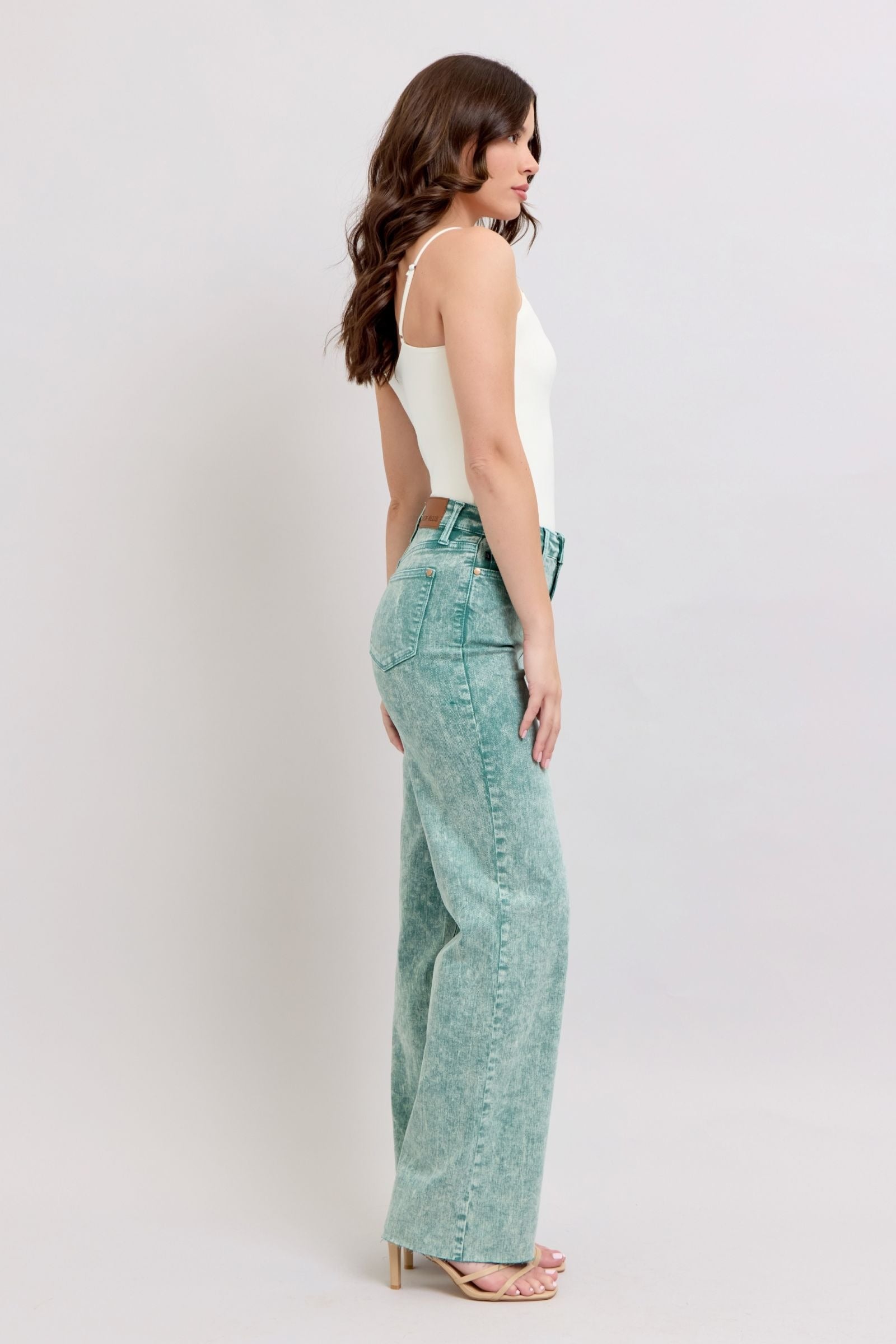High waist sea green garment dyed jeans with a relaxed dad jean cut and raw hem.