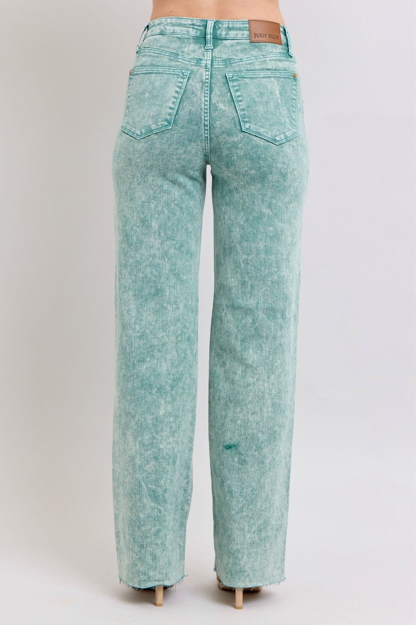 High waist sea green garment dyed jeans with raw hem finish.