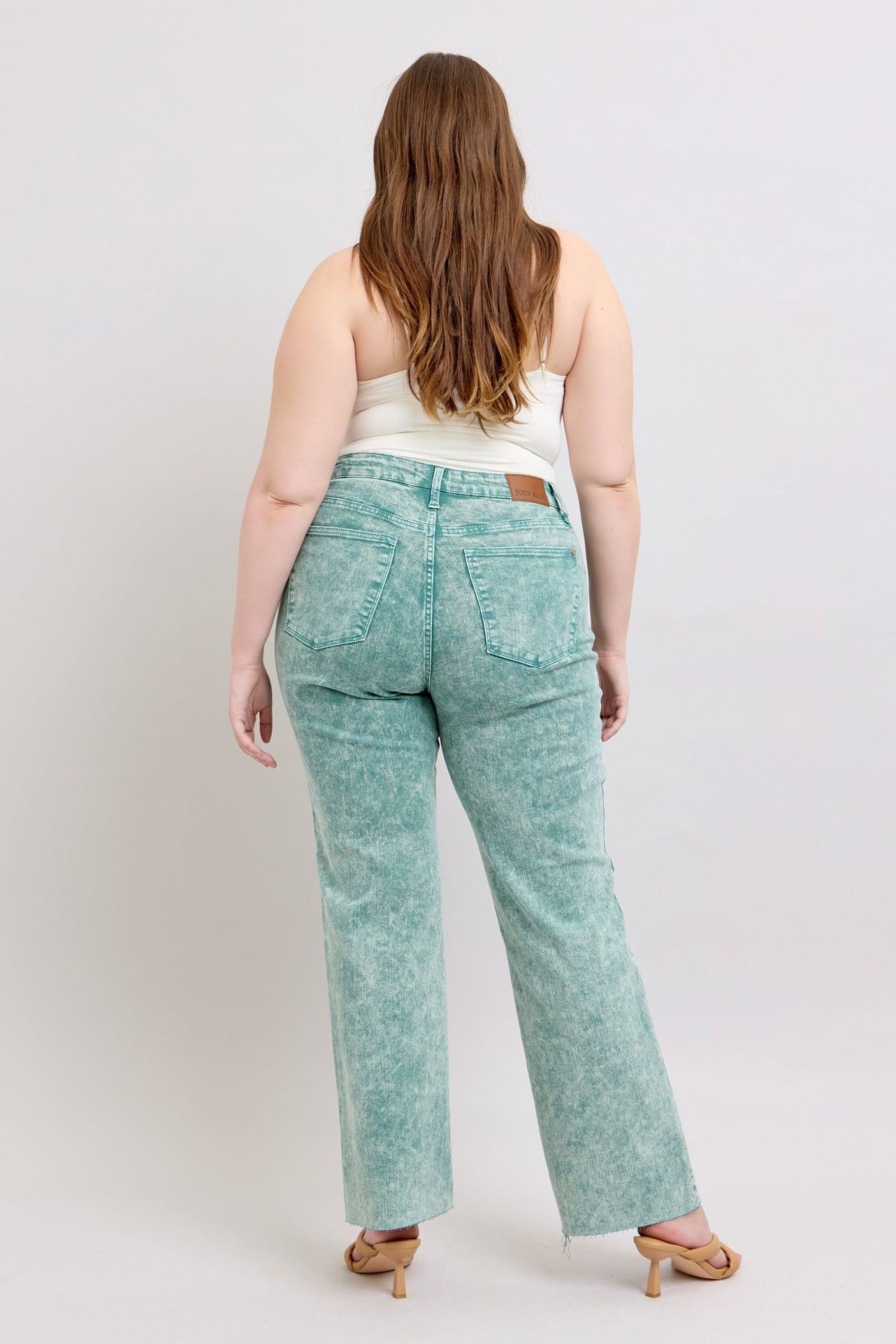 High waist garment dyed sea green jeans with raw hem.
