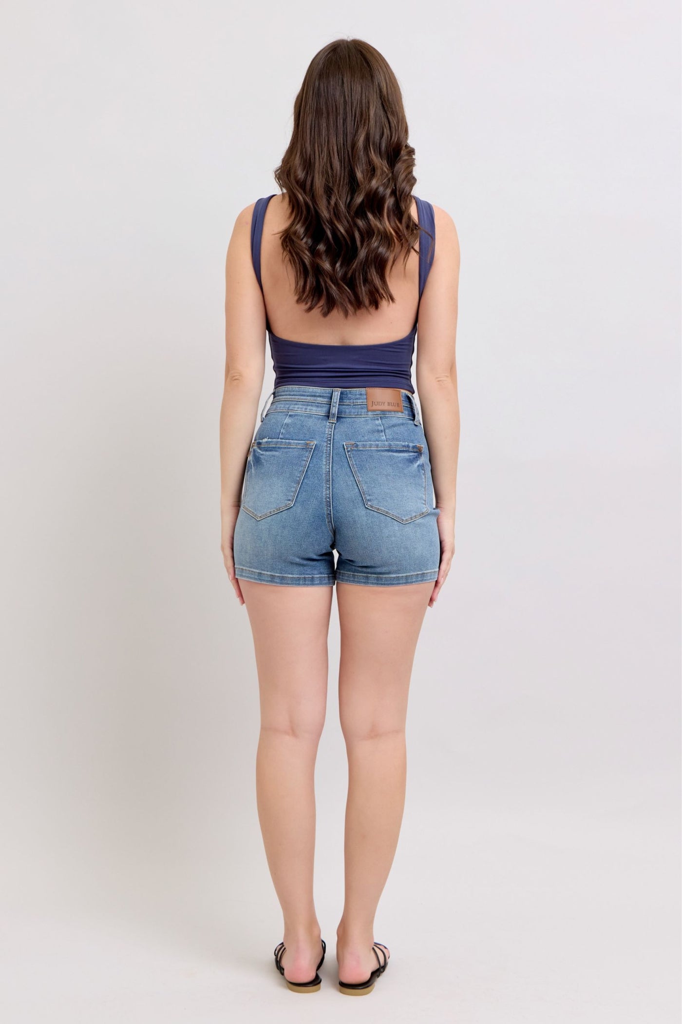 Highwaist tummy control denim shorts with double waistband seen from the back.