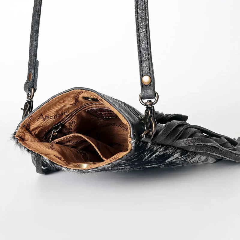American Darling crossbody messenger bag ADBGS153ACSLFRNG in genuine full grain cowhide leather with hair-on finish, leather fringes, adjustable strap, and antique metal fittings.