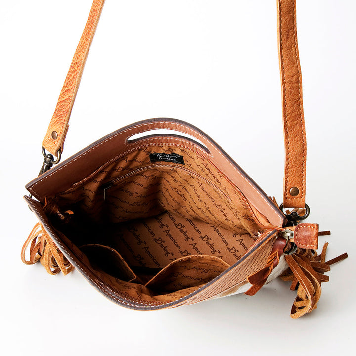 Open American Darling Clutch Handbag ADBGS145TAW made of hand-tooled genuine full grain vegetable tanned leather with fringes and adjustable strap.