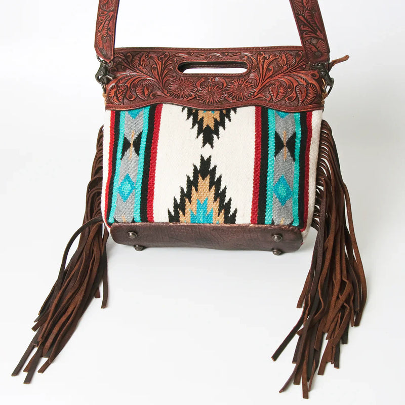 American Darling Clutch ADBG247 with handwoven wool saddle blanket, genuine full grain leather, hair-on cowhide embellishment, leather fringes, adjustable leather strap, and antique metal fittings