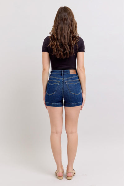 Woman wearing high waist Judy Blue denim shorts with tummy control, viewed from back