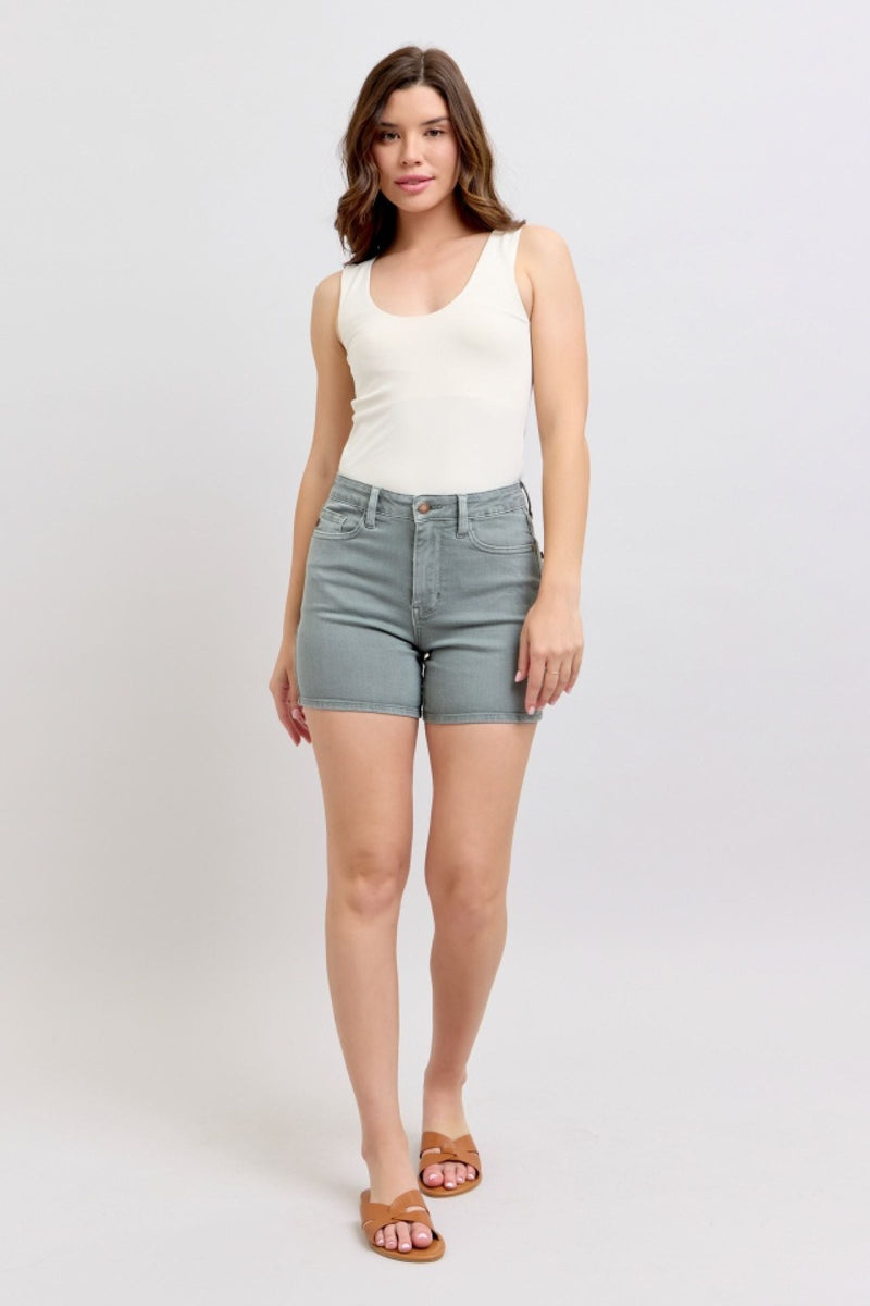 Judy Blue high waist garment dyed shorts with pocket embroidery in blue denim on model