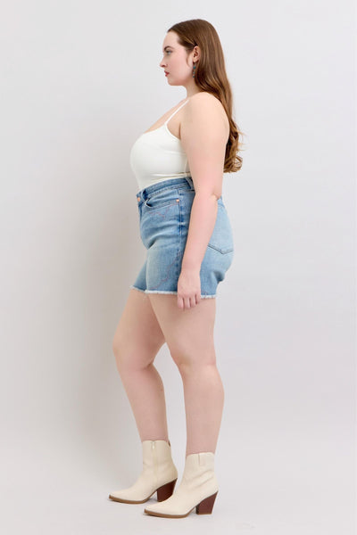 Judy Blue Shorts with high-rise cut, western embroidery, raw cut-off hem, and stretch blend.