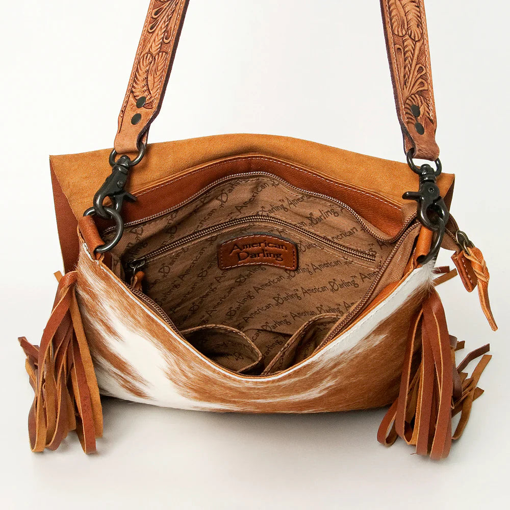 American Darling genuine leather crossbody messenger bag with cowhide hair-on leather, leather fringes, and tooled leather strap interior view