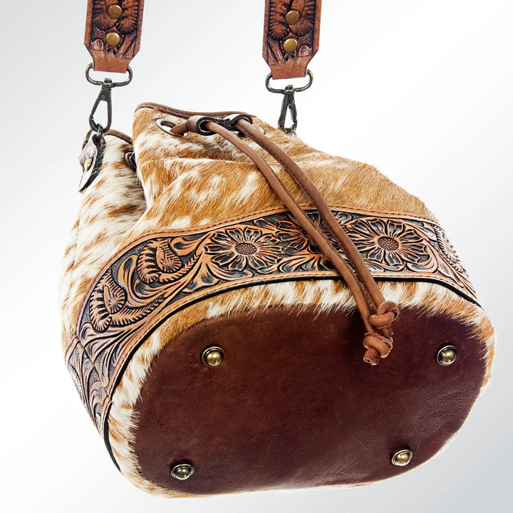 American Darling Bucket Bag ADBG569TAW in hand-tooled vegetable tanned cowhide leather with handpicked cowhide hair-on detail and adjustable shoulder strap