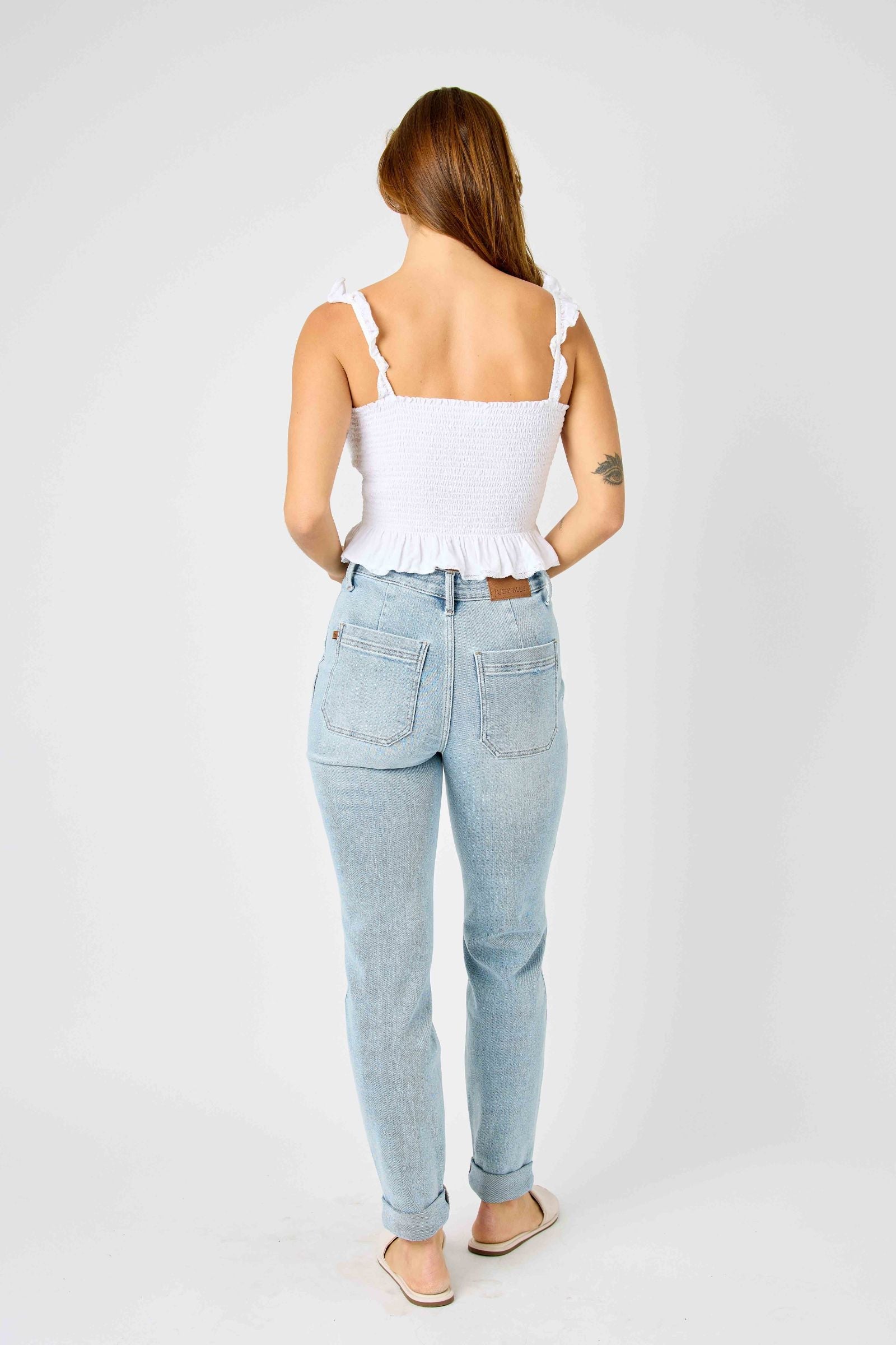 Woman wearing high waist Judy Blue Jeans vintage double-cuffed jogger in light wash denim from back view