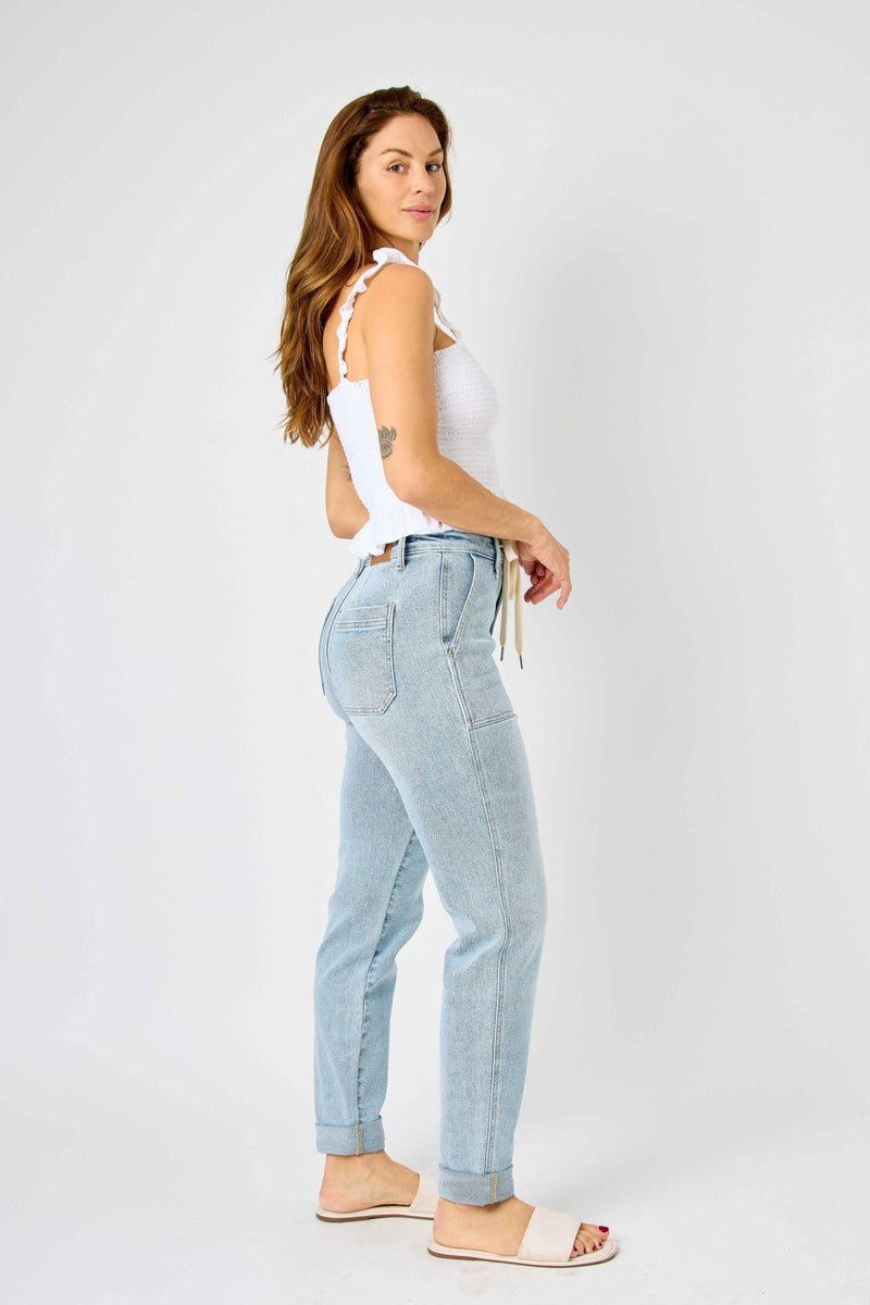 Woman wearing high waist vintage double-cuffed Judy Blue Jeans joggers in light wash denim