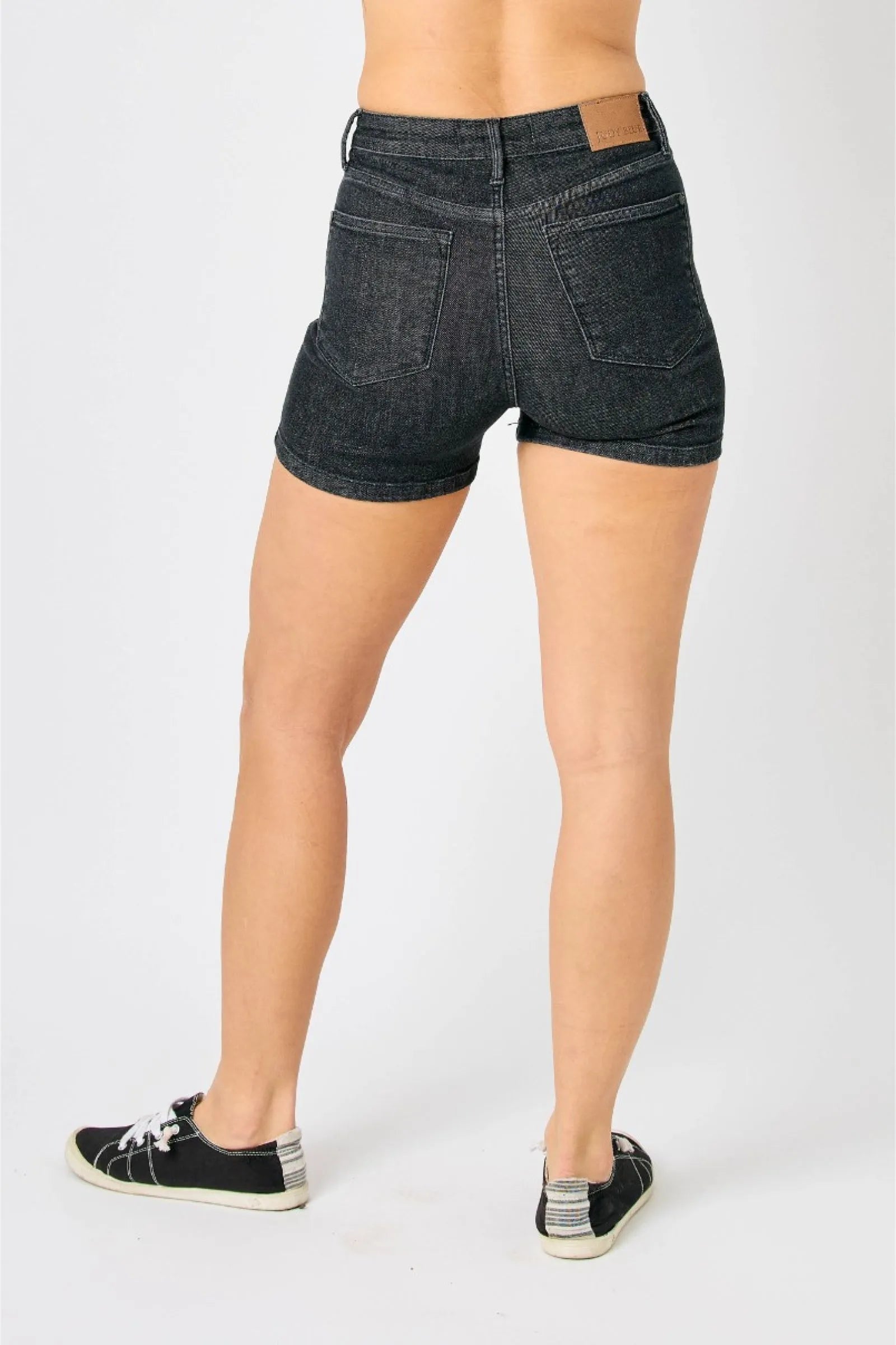 Mid rise Judy Blue shorts with tummy control and vintage wash, featuring release hem and stretchy denim.